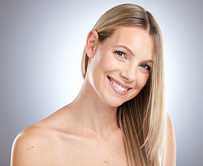 Image showing Portrait, face and hair with a model woman in studio on a gray background for natural haircare or keratin product. Skincare, happy and smile with a young female posing for hair care treatment
