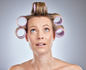 Image showing Hair, beauty and woman with roller in studio on gray background for wellness, hairstyle and hair care. Fashion, beauty salon and comic face of girl with hair curler, cosmetics and hair treatment