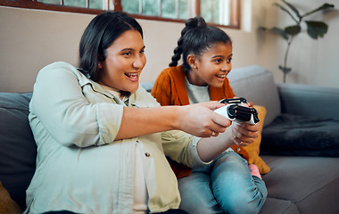 Image showing Family, video game and online gaming on home sofa with a pregnant mother and daughter on a living room couch together while happy and having fun. Woman and girl kid together for esports competition