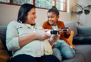 Image showing Mother, child and video game in home to relax together for happy family bonding on weekend. Wellness, happy and pregnant mom playing joystick game with kid on sofa for fun moment in house.