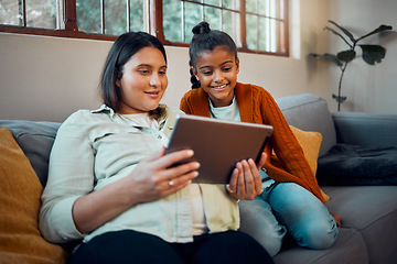 Image showing Tablet, pregnant mother and girl watching cartoon and children movie streaming on a sofa. Mom, child and internet gaming together with bonding, love and care on a home living room couch