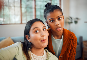 Image showing Selfie, mother and daughter with funny, comic face and bonding in home lounge with love, care or together. Mom, girl child and digital picture for happiness, crazy time or social media in living room