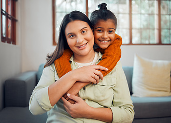 Image showing Family, portrait and mother with girl on a sofa embrace, relax and smile in their home together. Face, mom and child hugging on a couch, enjoying bond, weekend and quality time in a living room