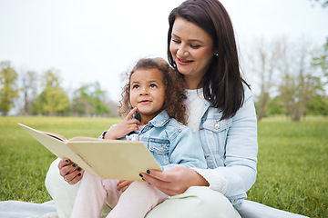 Image showing Children park, reading and mother with a girl and story book with happiness from creative development. Happy, relax and interracial family on a picnic blanket outdoor feeling calm with reading book