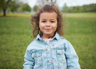 Image showing Child, face and park with a smile outdoor on a grass field for freedom, play and summer vacation while happy and excited. Portrait of girl kid toddler in nature for fun spring travel adventure in UK