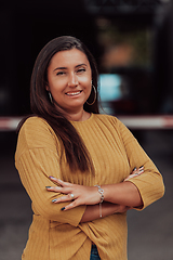 Image showing A powerful portrait of a businesswoman, standing confidently with her arms crossed, representing the determination of the female gender and embodying strength and success