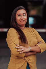 Image showing A powerful portrait of a businesswoman, standing confidently with her arms crossed, representing the determination of the female gender and embodying strength and success