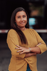 Image showing A powerful portrait of a businesswoman, standing confidently with her arms crossed, representing the determination of the female gender and embodying strength and success