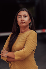 Image showing A powerful portrait of a businesswoman, standing confidently with her arms crossed, representing the determination of the female gender and embodying strength and success