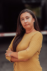 Image showing A powerful portrait of a businesswoman, standing confidently with her arms crossed, representing the determination of the female gender and embodying strength and success