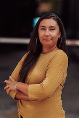 Image showing A powerful portrait of a businesswoman, standing confidently with her arms crossed, representing the determination of the female gender and embodying strength and success