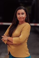 Image showing A powerful portrait of a businesswoman, standing confidently with her arms crossed, representing the determination of the female gender and embodying strength and success