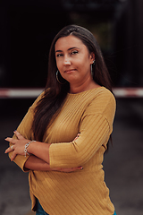 Image showing A powerful portrait of a businesswoman, standing confidently with her arms crossed, representing the determination of the female gender and embodying strength and success