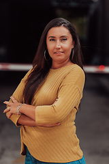 Image showing A powerful portrait of a businesswoman, standing confidently with her arms crossed, representing the determination of the female gender and embodying strength and success