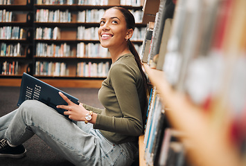 Image showing Student, library and smile for reading books in learning, education or knowledge at university. Happy woman smiling enjoying book read, story or study in research for assignment or project at campus