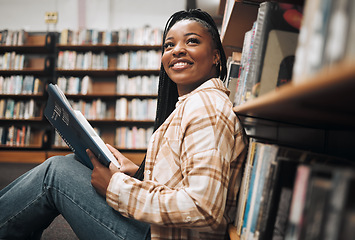 Image showing University, education and black woman in library reading book. College scholarship, student and happy female learner thinking about studying, knowledge and learning while sitting by bookshelf or case