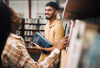 Image showing Talking students, bonding and library bookshelf on school, college and university campus for education, learning and religion studying. Smile, happy man and black woman friends with textbook research