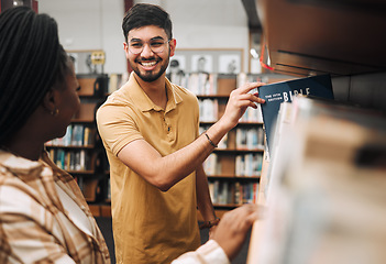 Image showing Studying religion, research and students in library, college bookshelf and happy with knowledge on campus. Smile, choice and couple of friends with scholarship for learning, education and university