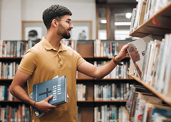 Image showing University, student or man with bible in a library to study spiritual religion knowledge, prayer or Christ bookshelf search. Smile, school or happy man in college studying or worship research in God