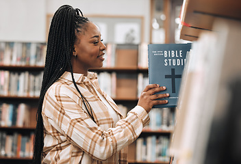 Image showing Religion book, education and black woman in a library for research, studying God and knowledge on the bible at college. Learning, smile and African student with decision of books on a scholarship