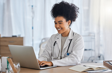 Image showing Black woman, doctor and laptop with smile for healthcare, email or telemedicine by work desk at the hospital. African American female medical expert smiling on computer in medicare research at clinic