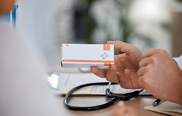 Image showing Hand, doctor and pills for healthcare, medicine and treatment in office with patient closeup. Hands, medication and box by medical expert for prescription, health and recovery during hospital consult