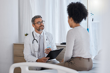 Image showing Doctor, patient and hospital consultation while talking about healthcare, health insurance and results with checklist for examination and therapy. Man and woman together for wellness and counseling