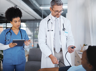 Image showing Doctor, patient and blood pressure in clinic with nurse, tablet and analysis for teamwork, health or job. Healthcare expert, medical support and tech for consulting, help or wellness advice in Cuba