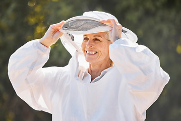 Image showing Beekeeper, safety suit and senior farm worker woman ready for honey, bee and produce production. Happy, agriculture and elderly sustainability worker in garden or field with a smile with safety