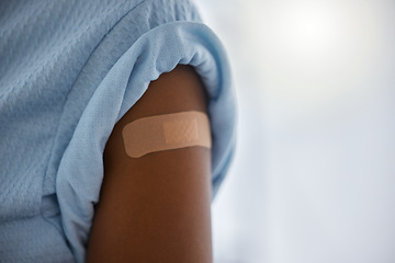 Image showing Covid, vaccine and plaster on the arm of a patient in a hospital after a booster shot for cure or treatment. Compliance, corona virus and healthcare with a person in a clinic for security regulations