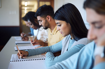 Image showing Students, writing exam and studying in classroom for education, university learning and test document. Young college people, knowledge and scholarship for assignment paperwork or degree information