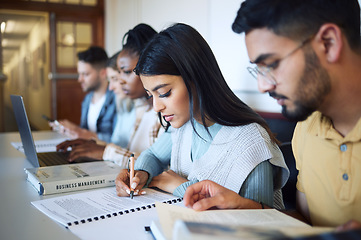 Image showing University, education and students studying for exam, test or assignment in the library on campus. Scholarship, knowledge and young friends learning in college class with technology and information.