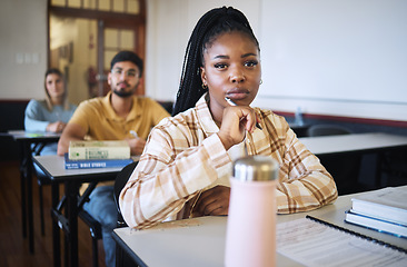 Image showing University, education and thinking with a student black woman in class during a lecture or lesson for learning. Study, school or scholarship with a female pupil sitting in a classroom for development