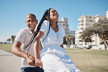 Image showing Date, bike and summer with a black couple having fun together in a park by the promenade during vacation. Cycling, laughing and comic with a man and woman tourist enjoying travel on holiday