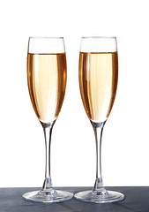 Image showing Two elegant champagne glasses on a dark surface