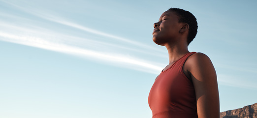 Image showing Fitness, breath and mockup with a sports black woman taking a break outdoor against a clear blue sky. Exercise, breathing and motivation with a female athlete or runner outside during summer in space