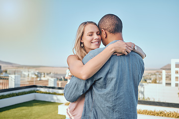 Image showing Rooftop, love and couple hug in city enjoying summer holiday, weekend and vacation in Los Angeles. Romance, relationship and interracial man and woman embrace, bonding and hugging on urban adventure