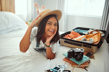 Image showing Travel, luggage and woman on bed with clothes, camera and suitcase for adventure, holiday and vacation. Traveling lifestyle, freedom and portrait of girl in bedroom pack for journey, tourism and trip