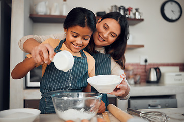 Image showing Baking, children and kitchen with a mother and daughter learning about cooking or food in their home together. Family, love and bonding with an indian woman teaching her female child how to bake