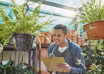 Image showing Plant, nursery and small business man writing on checklist for quality control, growth and development in a gardening shop with pot plants. Male working at eco startup as seller of garden inventory