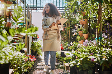 Image showing Store, flowers or black woman with checklist for quality control or quality assurance monitoring plants growth. Small business, gardening or florist worker writing on clipboard for floral inspection