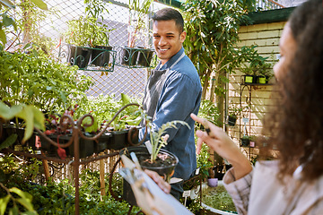 Image showing Gardening, flowers and plants with a couple checking in the garden together for a botany hobby at home. Nature, spring and sustainability with a man and woman growing a flower or plant in a nursery