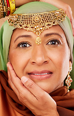 Image showing Face, beauty and jewelry on egyptian woman with hands on face for arab culture with hands on face for fashion and skincare. Portrait of a mature muslim female from Egypt with makeup and cosmetic