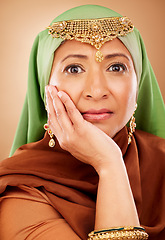 Image showing Portrait, muslim and beauty with a model woman in studio on a beige background for skincare or tradition. Face, fashion and culture with an attractive maturre islamic female proud of her heritage