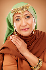 Image showing Muslim woman, face or fashion hijab on studio background in religion empowerment, Iranian human rights or Arabic jewelry design. Portrait, mature or Islamic beauty model in scarf or fabric aesthetic