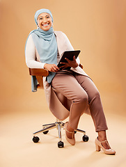 Image showing Muslim, woman and tablet technology on studio background for website, internet search and online app in chair. Happy portrait, islamic hijab and mature lady, model and digital connection in Malaysia