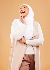 Image showing Fashion, beauty and Islamic woman with trendy clothes, wellness and thinking on brown studio background. Muslim female, Arabic lady and stylish hijab with smile, mockup and cosmetics with style.