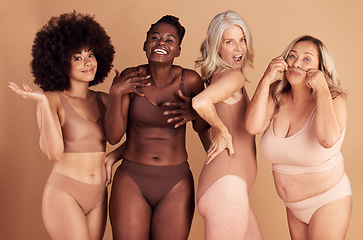 Image showing Lingerie, body positivity and women smile for diversity, self love and inclusive clothes against a brown studio background. Decision, happy and crazy portrait of small and plus size underwear model