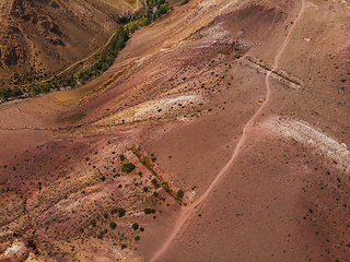 Image showing Aerial shot of the textured yellow nad red mountains resembling the surface of Mars