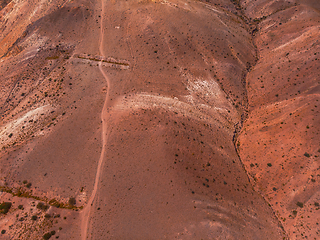 Image showing Aerial shot of the textured yellow nad red mountains resembling the surface of Mars